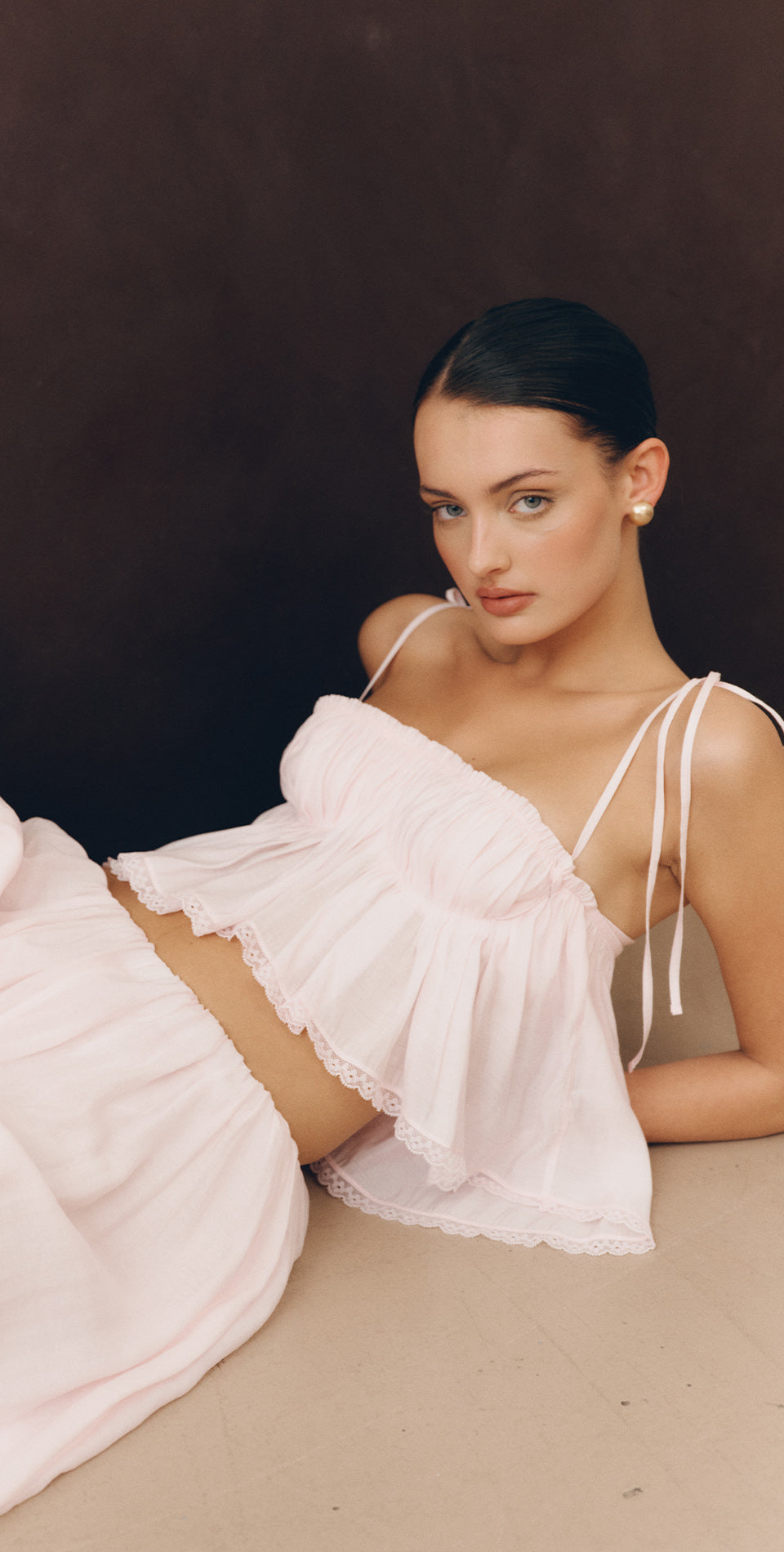 Model wearing the LENY Bustier Frill Top in soft pink with matching Balloon Trousers, styled as a feminine pink co-ord set.